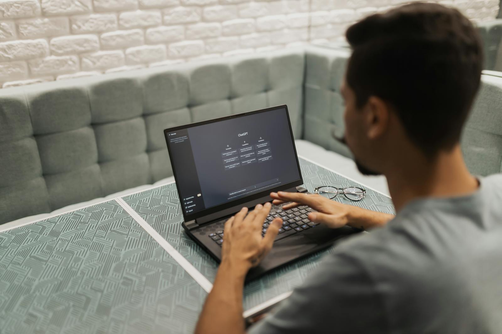 Person using an AI tool on a laptop in a modern office