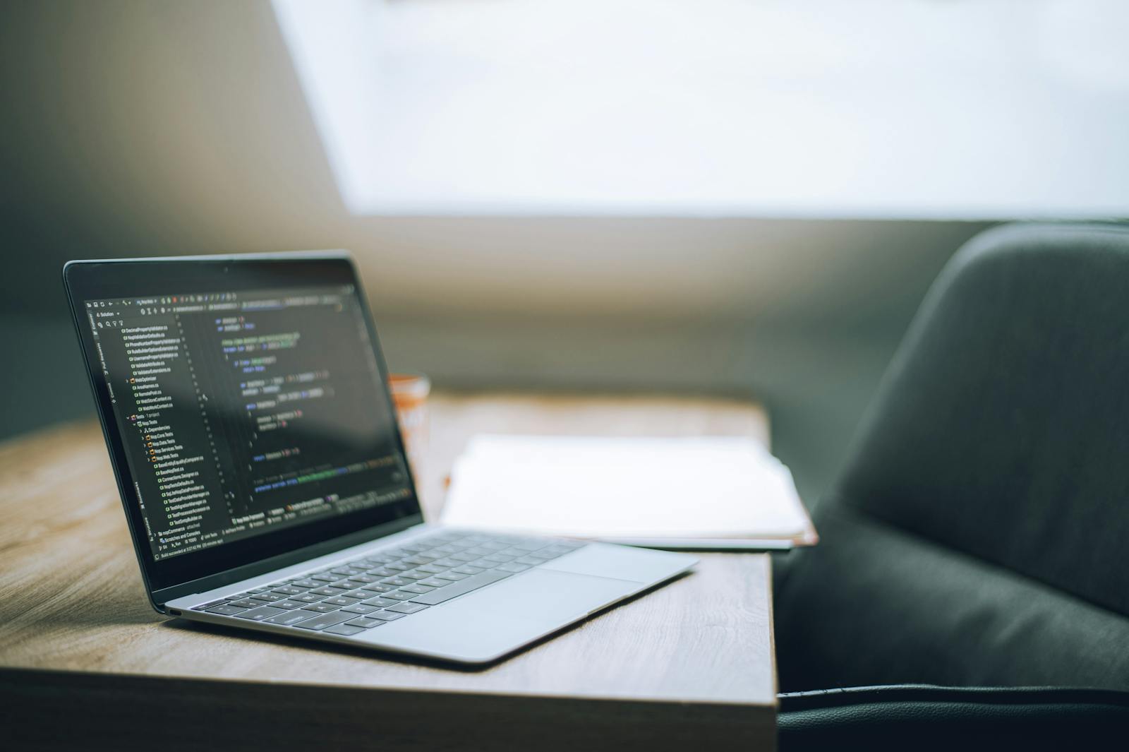 Open laptop on a desk in a bright office